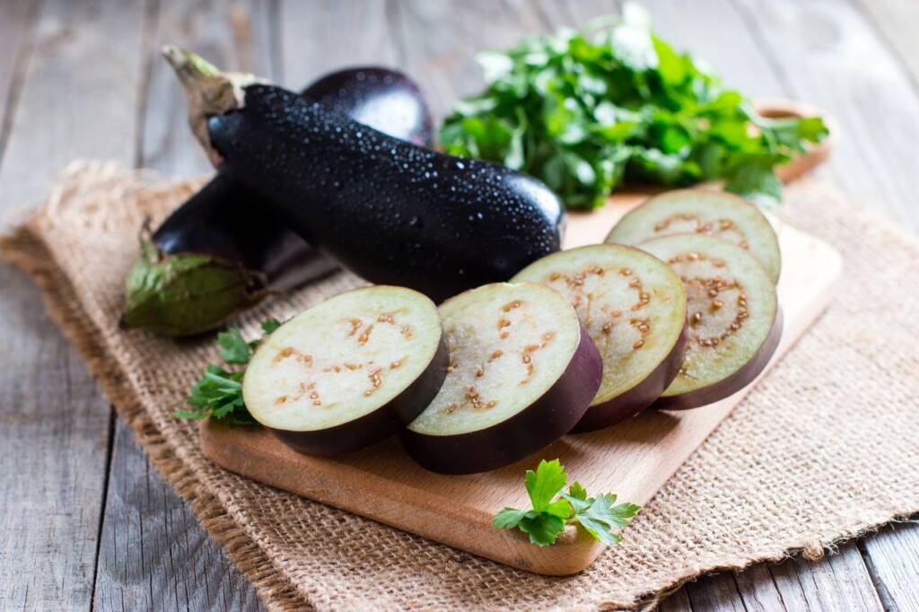 Premium Photo  Cook cuts the eggplant according to the recipe, on